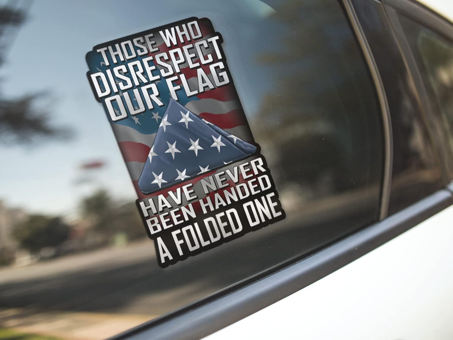 The Those Who Disrespect Our Flag decal on a car's side window